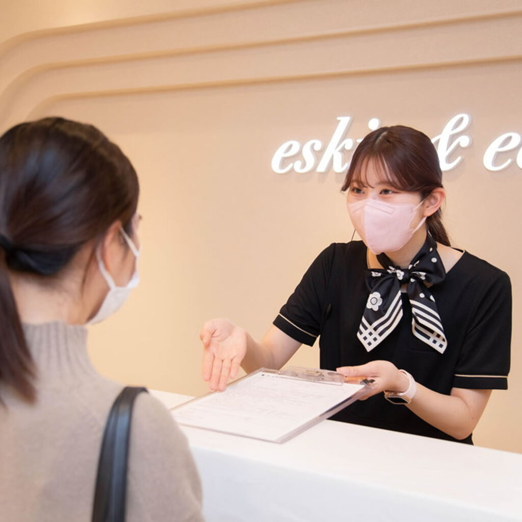 料金を説明する美容外科の受付スタッフ